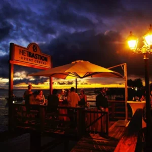 Mensen op verlicht terras aan water